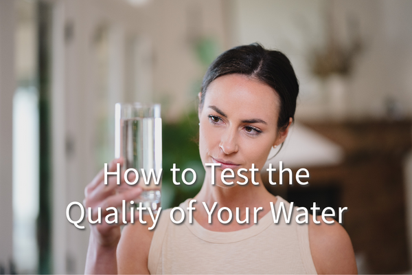 A women looking at a glass of water, questioning the quality