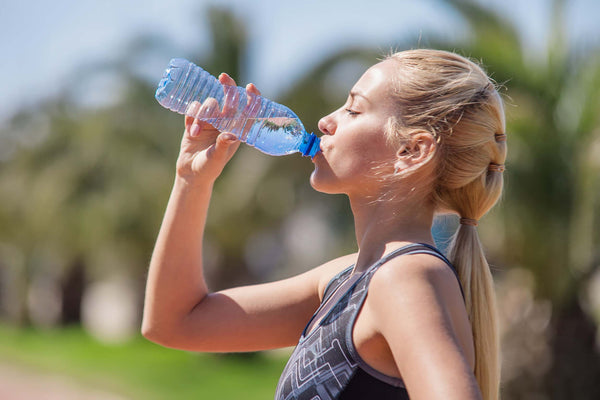 woman drinking daily bottled water